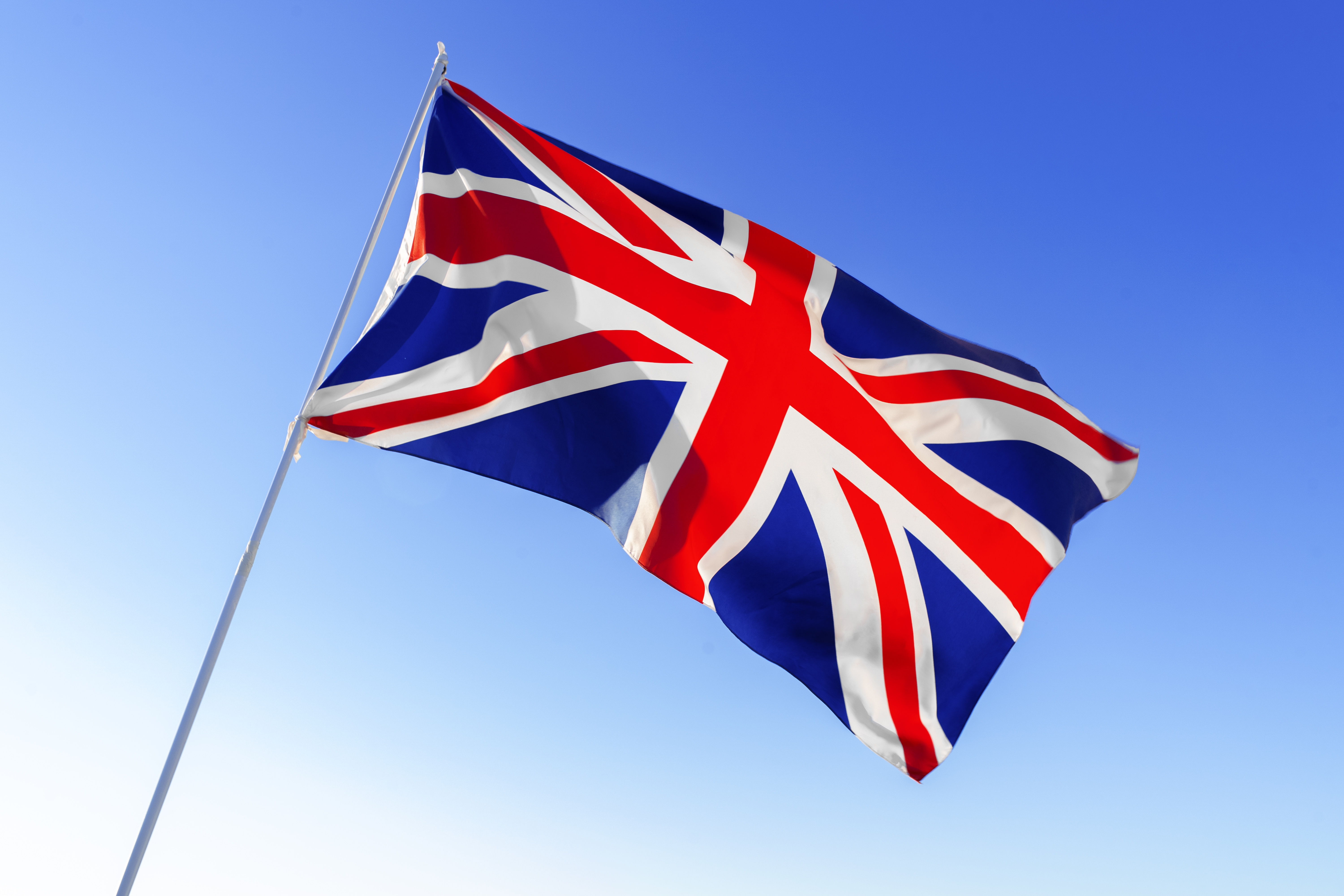 Flag of Great Britain waving against clear blue sky